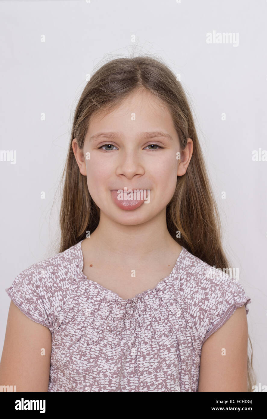 A girl showing her tongue Stock Photo