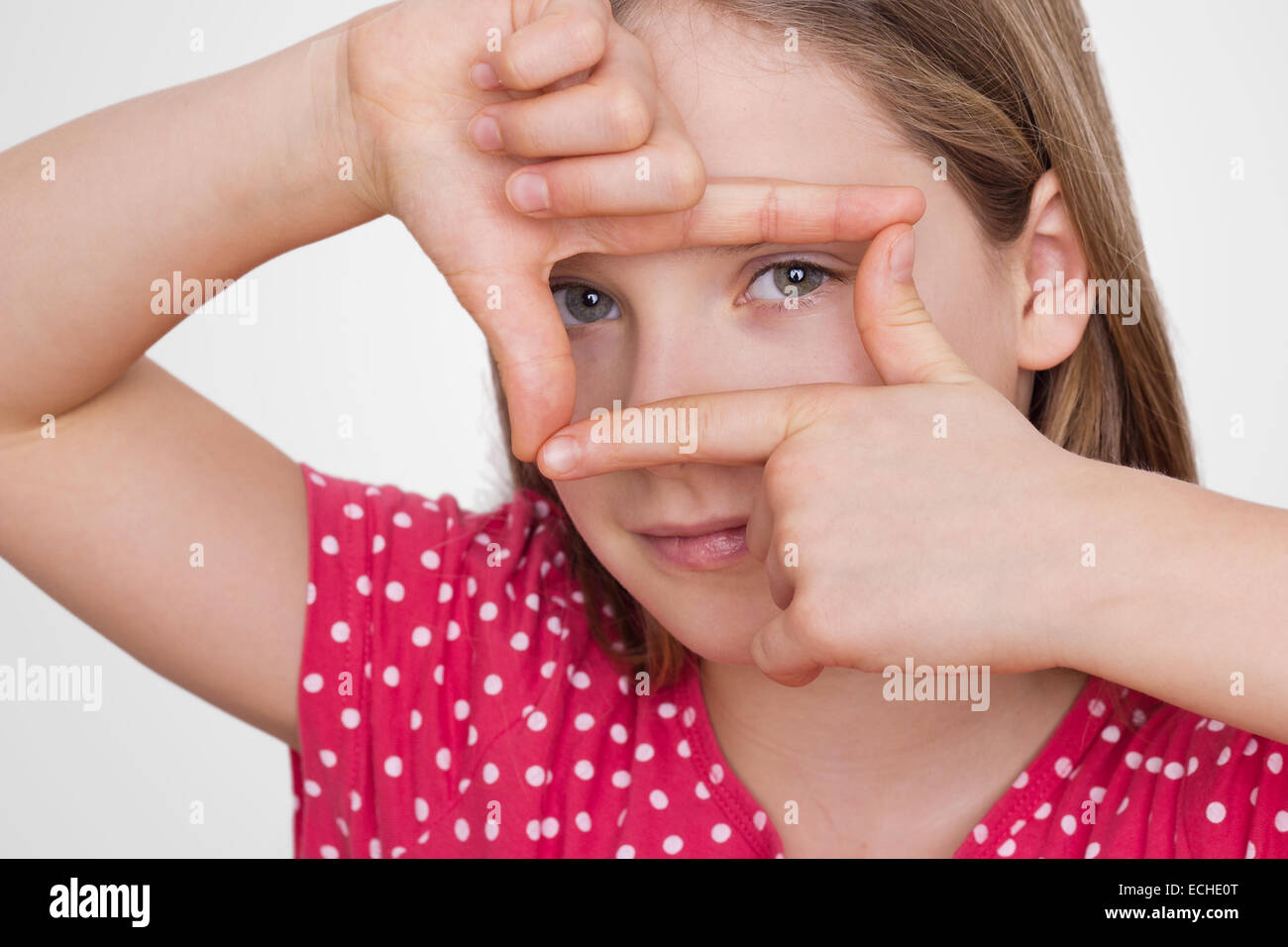 A girl looking with hands a picture Section Stock Photo