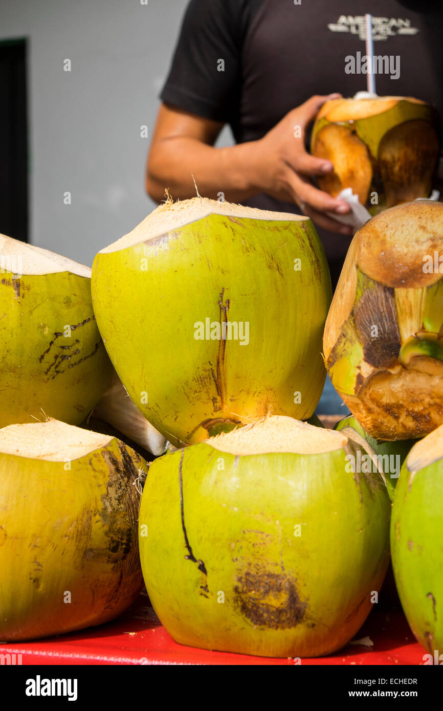 Several coconuts on a table being sold for the refreshing coconut water as a beverage and for the tasty meat. Puerto Vallarta, J Stock Photo