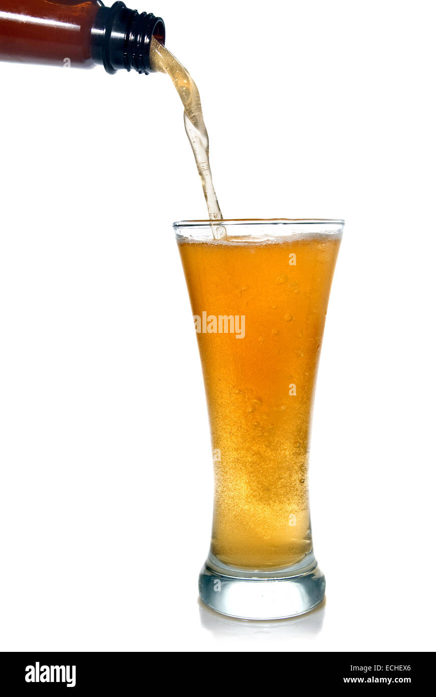 Beer pouring from bottle into glass isolated on white Stock Photo Alamy
