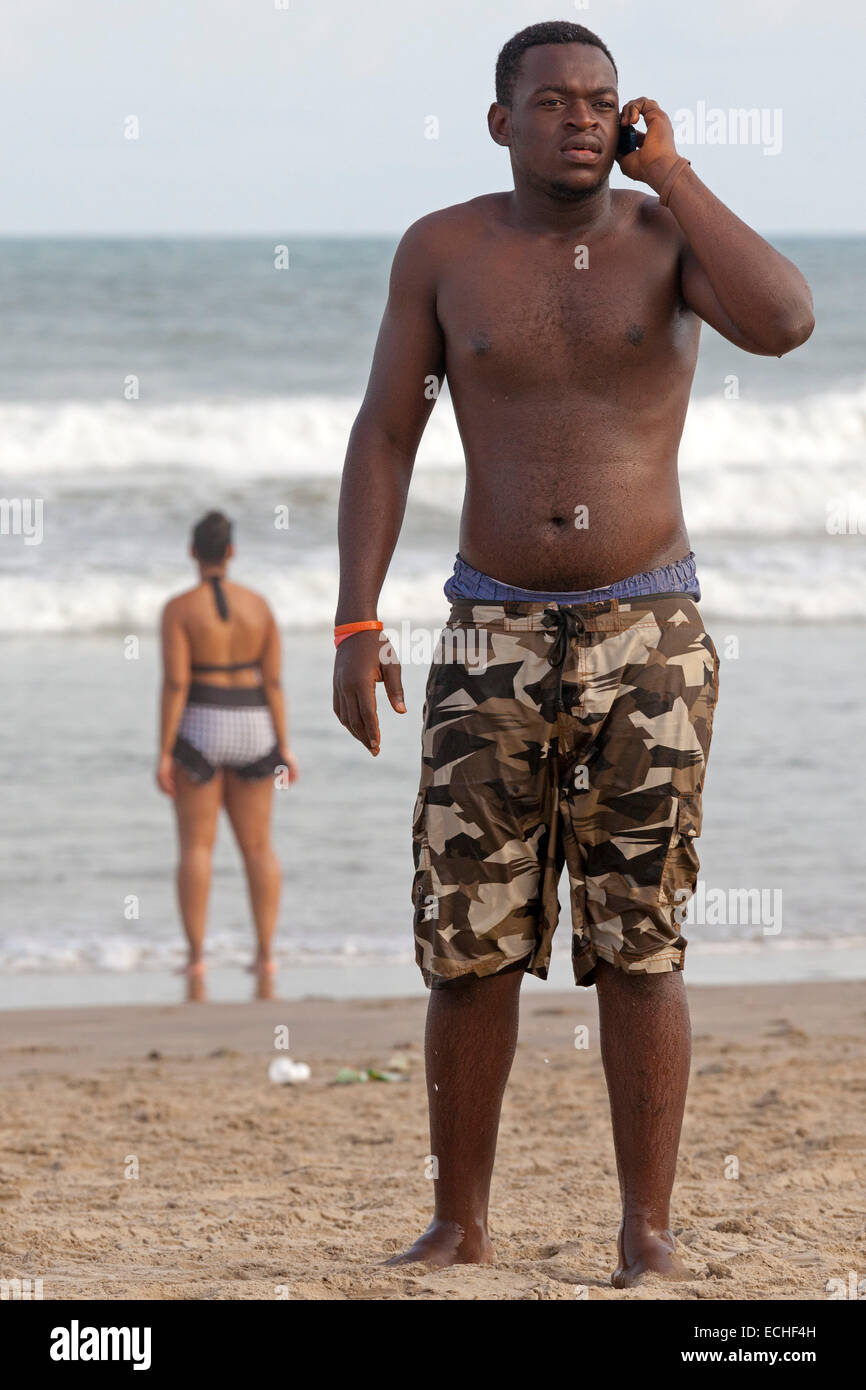 Man talking on mobile phone on Labadi beach, Accra, Ghana, Africa Stock Photo