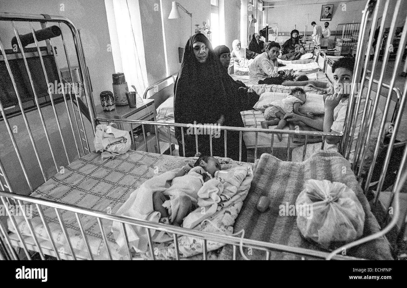 Muslim mothers stay with the babies in the infant ward of  Saddam Hussein Children's Hospital in Baghdad.  The children are suffering from dysentery and dehydration because the water treatment plant was bombed during the Gulf War and there is no clean drinking water.  The hospital has no medicine because of UN Sanctions after the war. Stock Photo