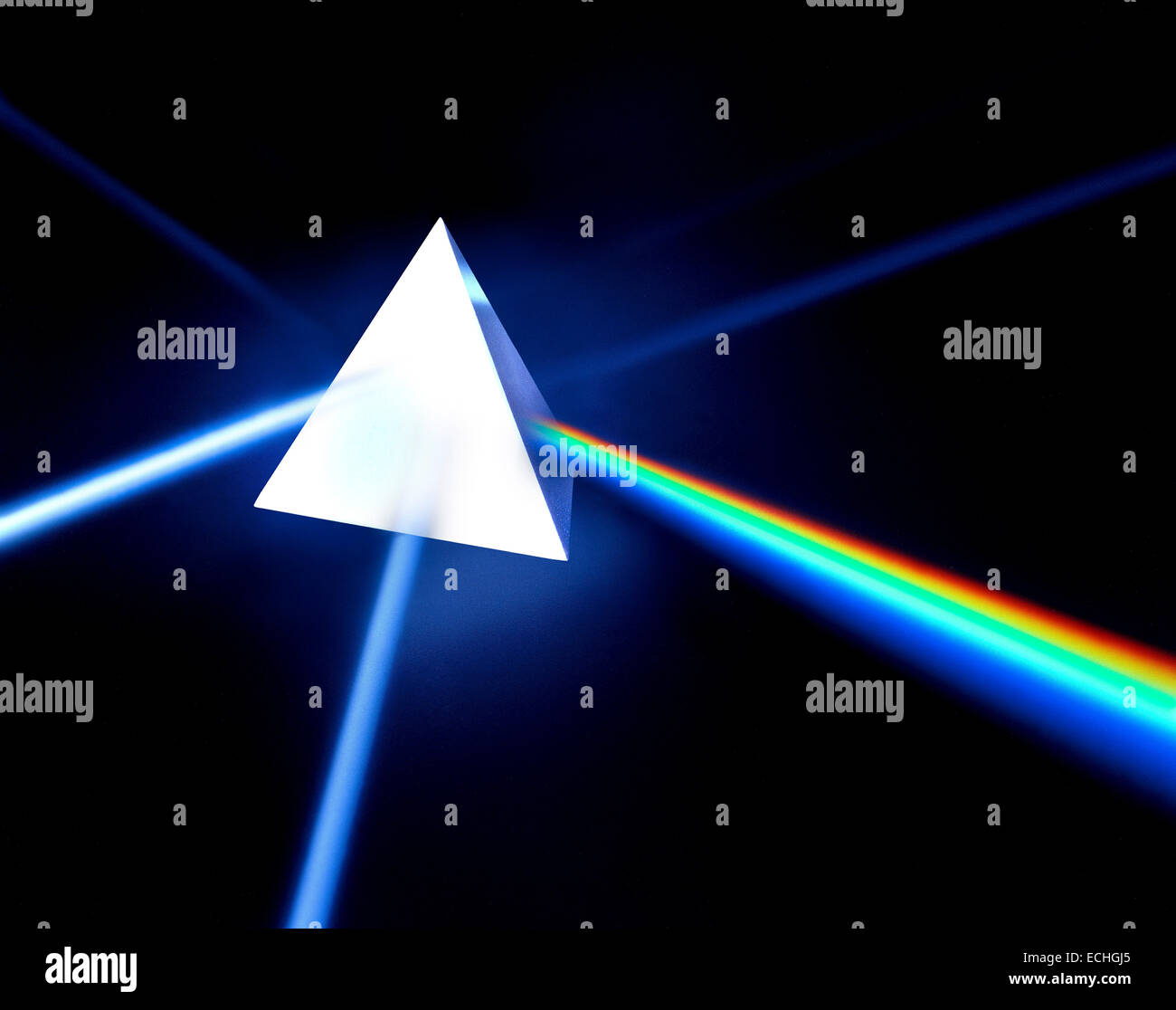 A pyramid prism photographed on black with light split into colour spectrum Stock Photo