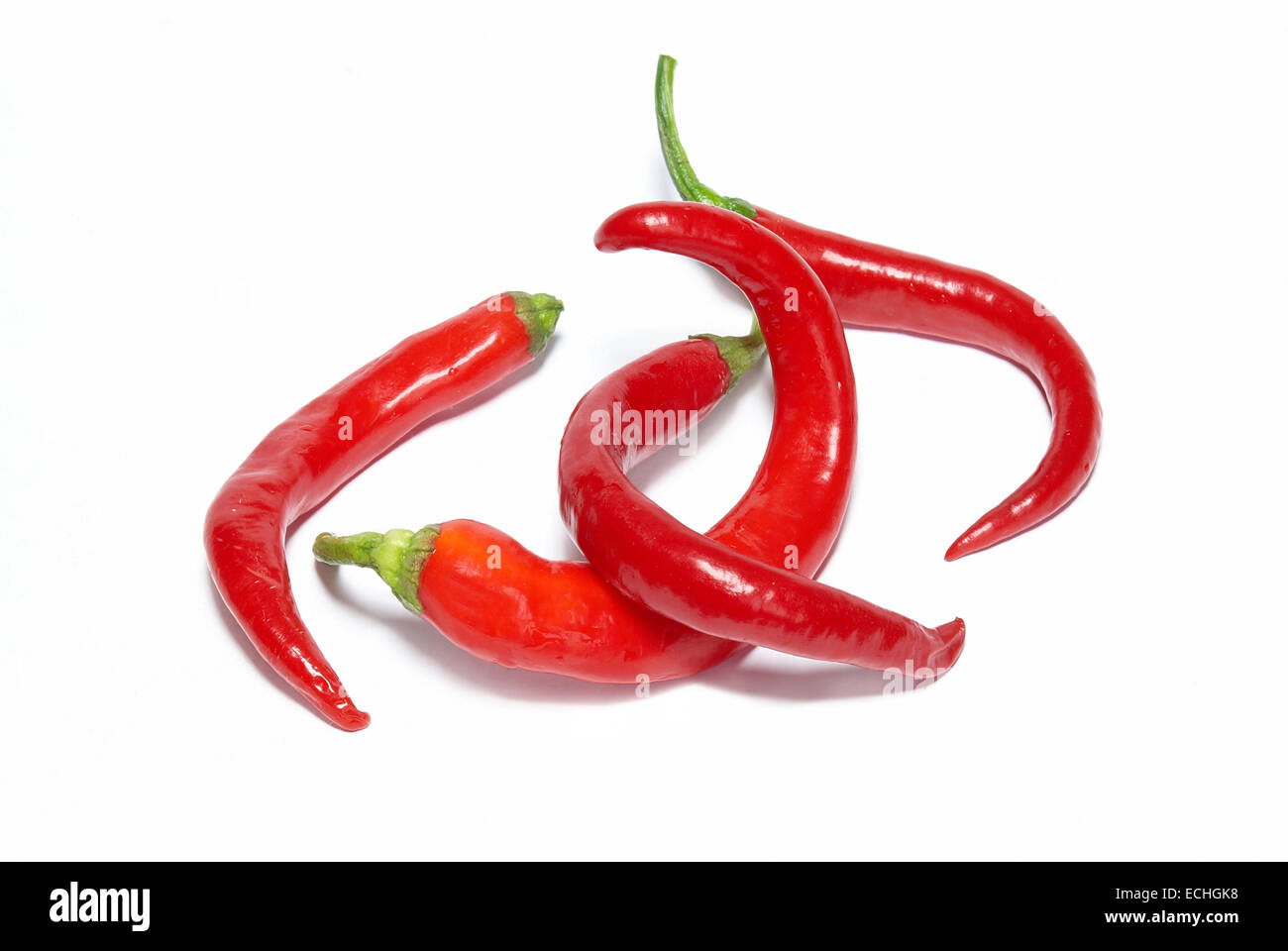 Stack of red hot chili peppers isolated on white Stock Photo - Alamy