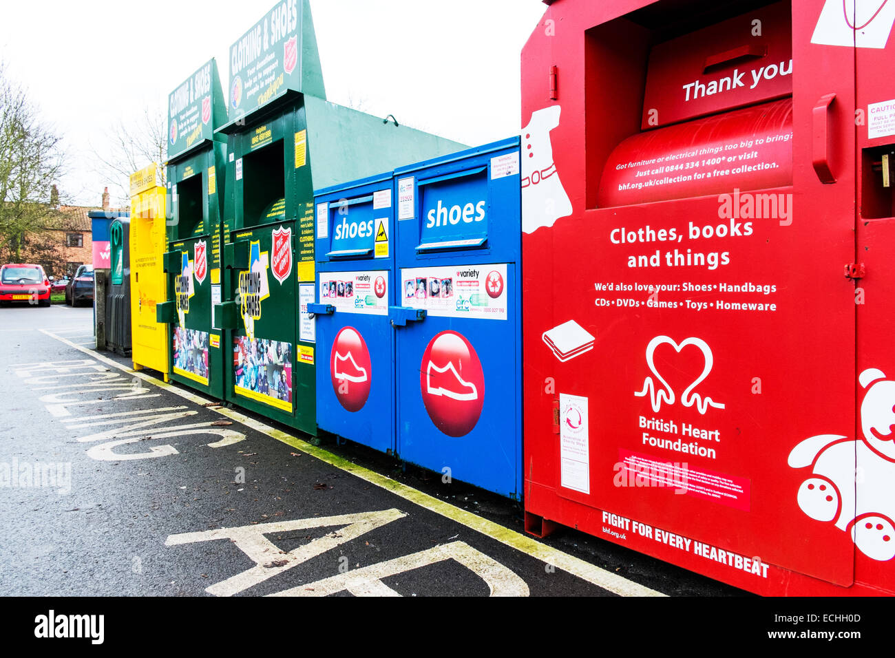 Recycling area charity bins collection collect disposal unwanted clothes shoes British heart foundation salvation army Stock Photo