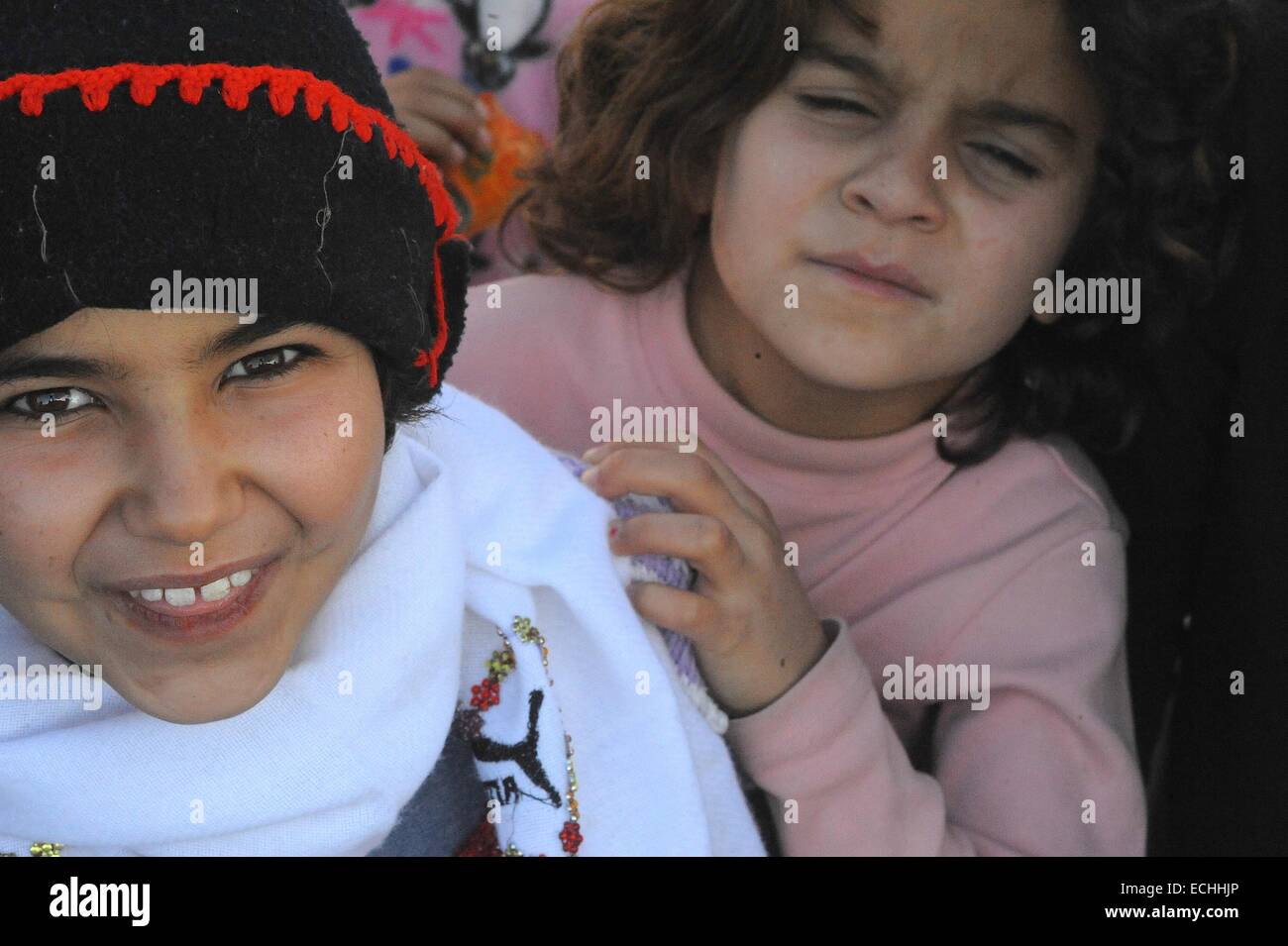 Suruc, Turkey. 15th Dec, 2014. Syrian Kurdish refugees face a difficult winter. The refugees who are trying to make the best of a difficult situation are close to their home in Kobani but must remain in the refugee camps in Turkey as fighting in Kobani between ISIL and Kurdish fighters are still a threat to their safety. According to the UNHCR 400,000 people from Kobani and its surrounding villages, most of them Kurds have fled into Neighbouring Turkey for shelter. Credit:  Gail Orenstein/ZUMA Wire/Alamy Live News Stock Photo