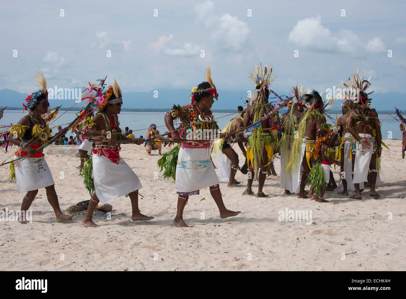 Melanesia, New Guinea, Papua New Guinea. Small island of Ali off the coast of mainland PNG. Local villagers dancing on beach. Stock Photo