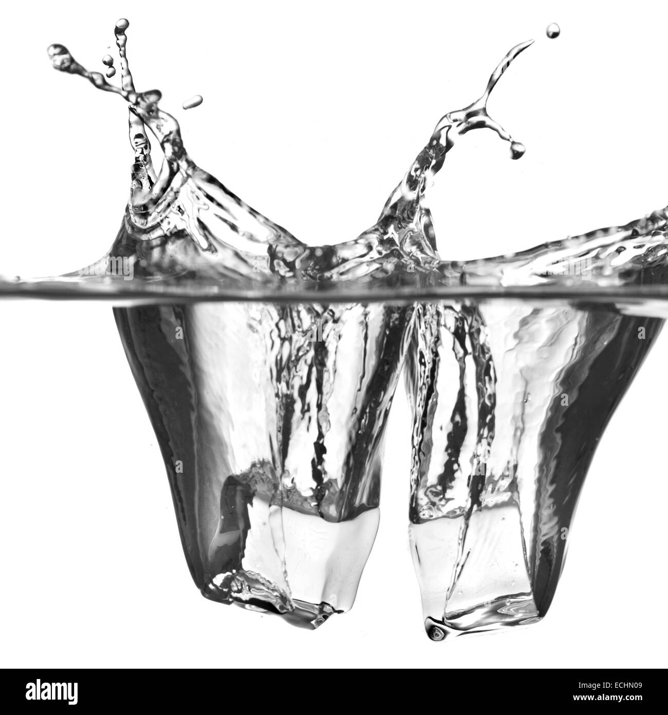 ice cubes dropped into water with splash isolated on white Stock Photo ...