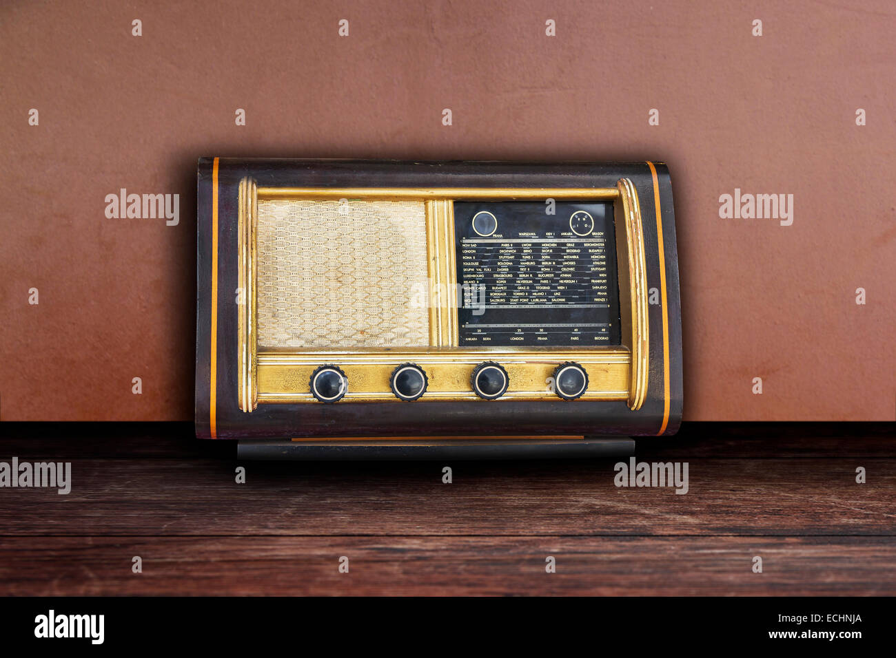 Old retro fashioned radio on wooden table and wall background Stock Photo