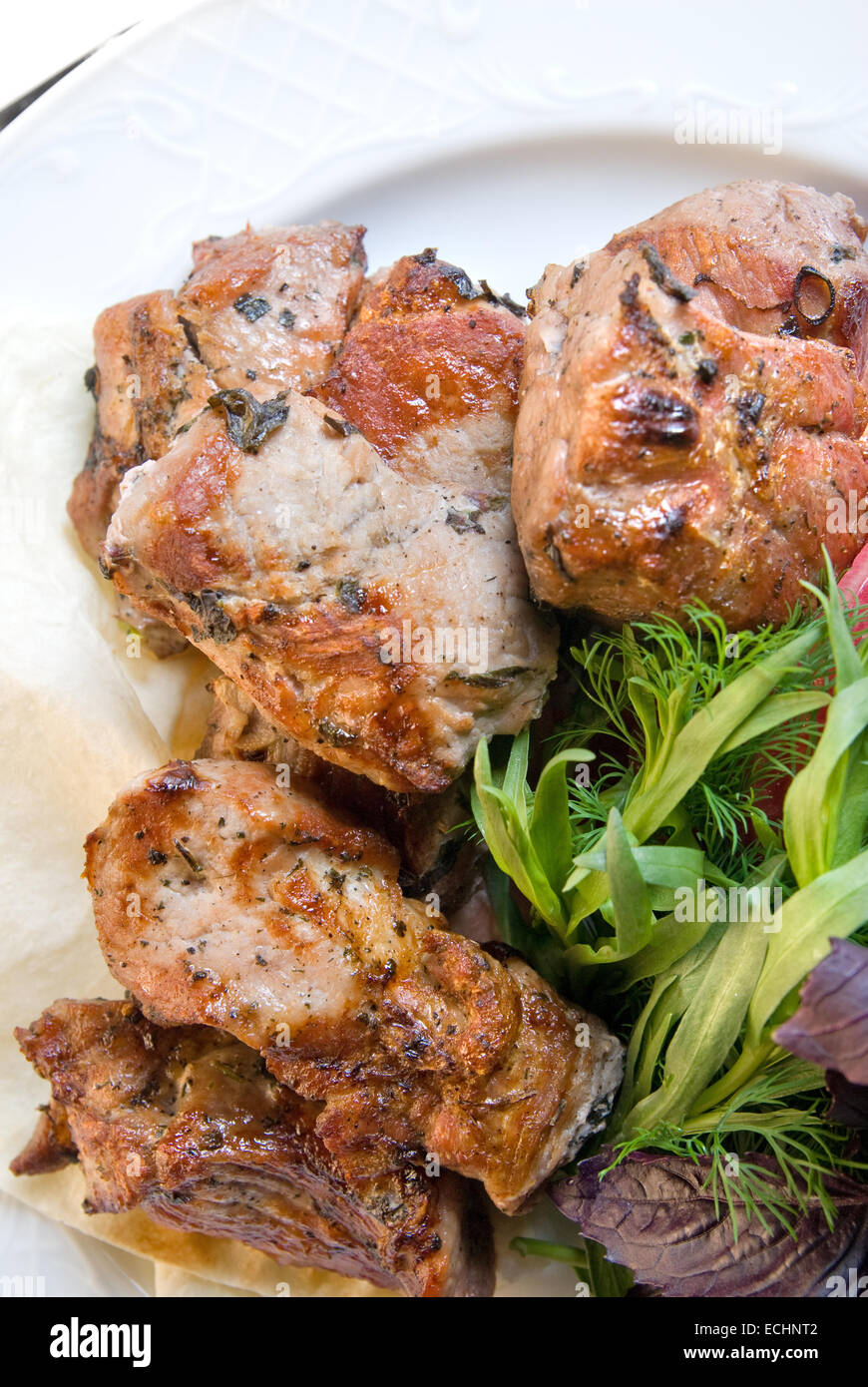 fried meat with potherbs on the plate Stock Photo