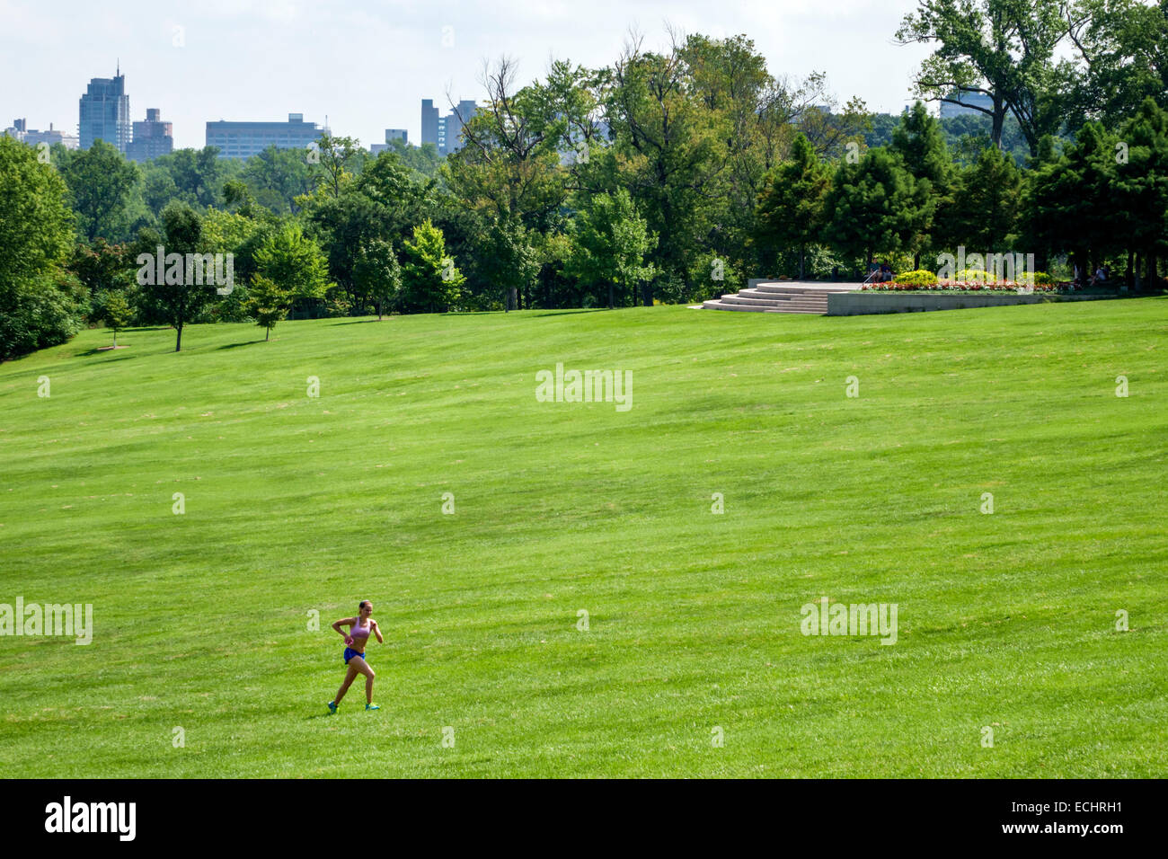 Saint St. Louis Missouri,Forest Park,urban public park,Art Hill,lawn,landscaping,trees,view,woman female women,fitness,running,jogging,uphill,skyline, Stock Photo