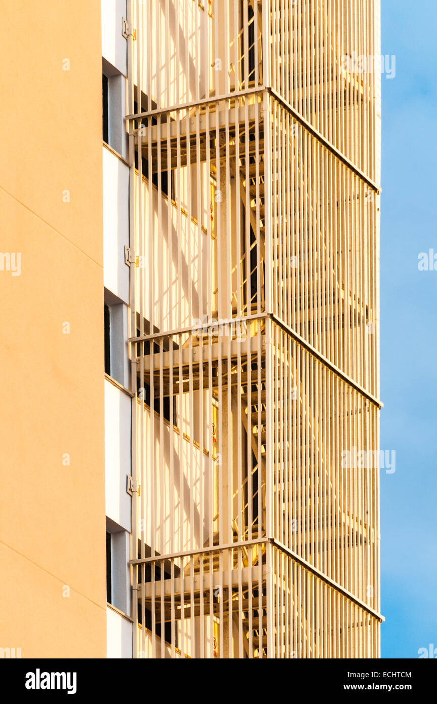 Enclosed fire escape stairs on the side of a hotel complex Stock Photo