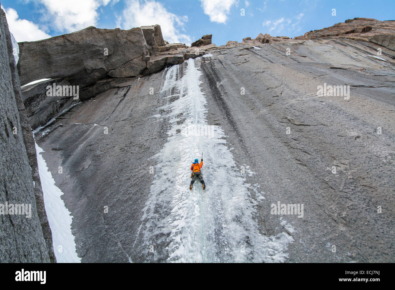 A climber leads a difficult first ascent of an ice climb in early fall