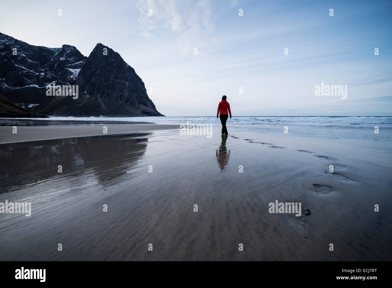 Person leaves footpints in sand at scenic Kvalvika beach, Moskenesøy, Lofoten Islands, Norway Stock Photo