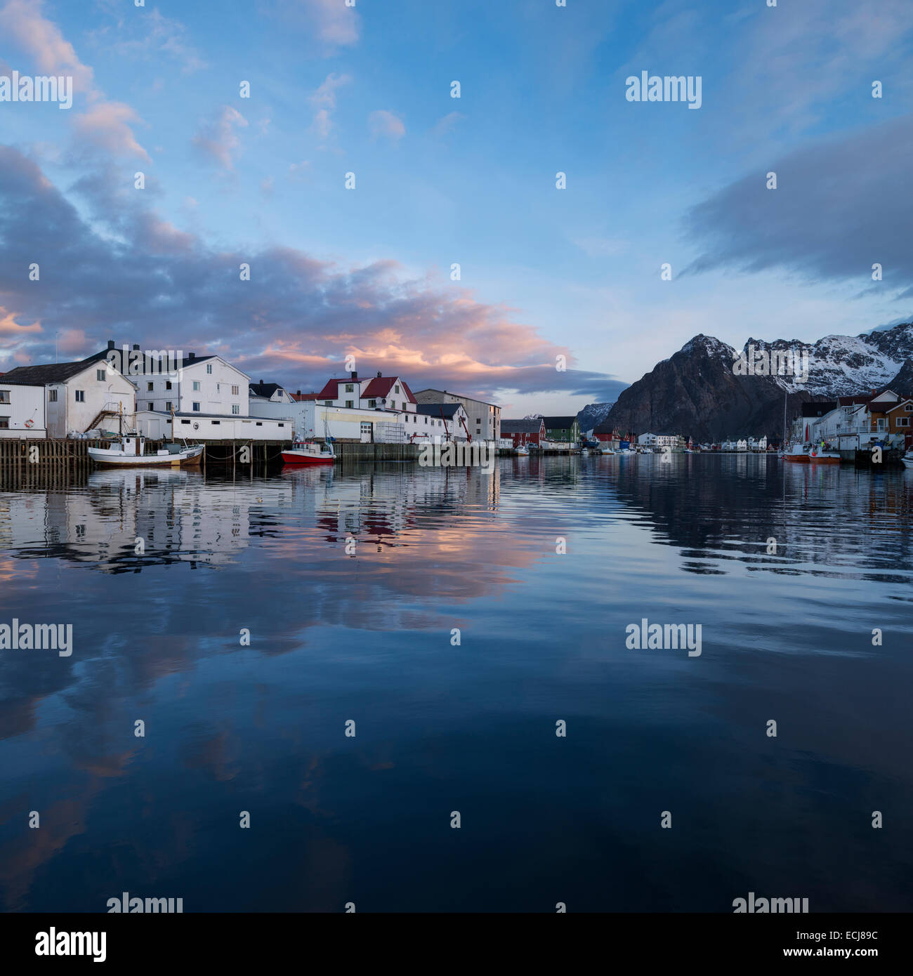 Mountain reflection in Harbour at scenic fishing village of Henningsvær, Austvågøy, Lofoten Islands, Norway Stock Photo