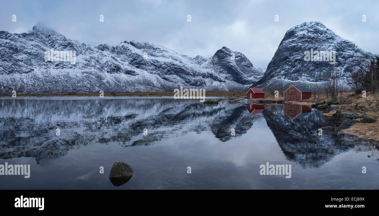 Boat sheds and mountains reflection on Selfjord in winter, Moskenesøy, Lofoten Islands, Norway Stock Photo