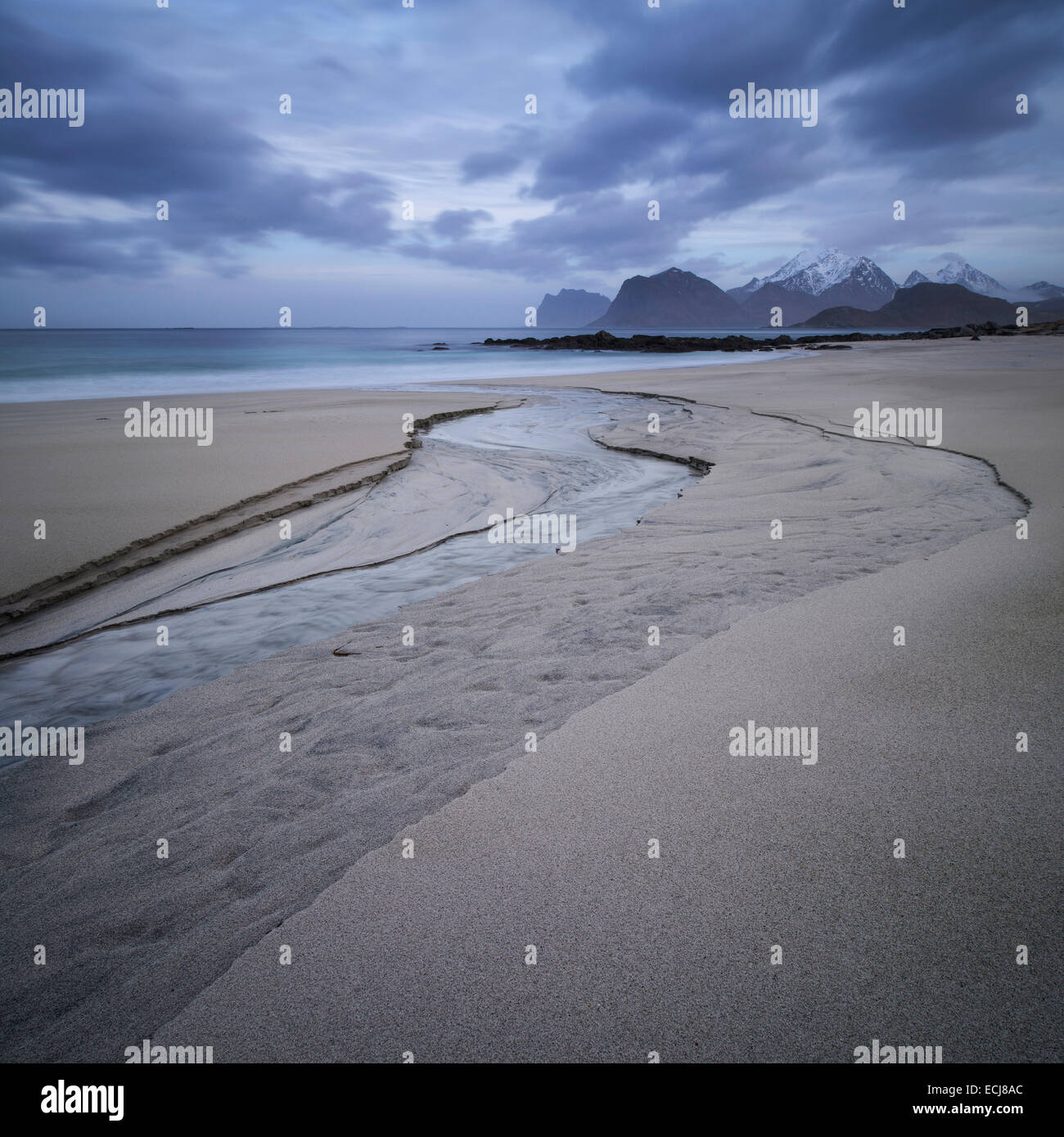 A small river runs through the sand at Storsandnes beach, Flakstadøy, Lofoten Islands, Norway Stock Photo