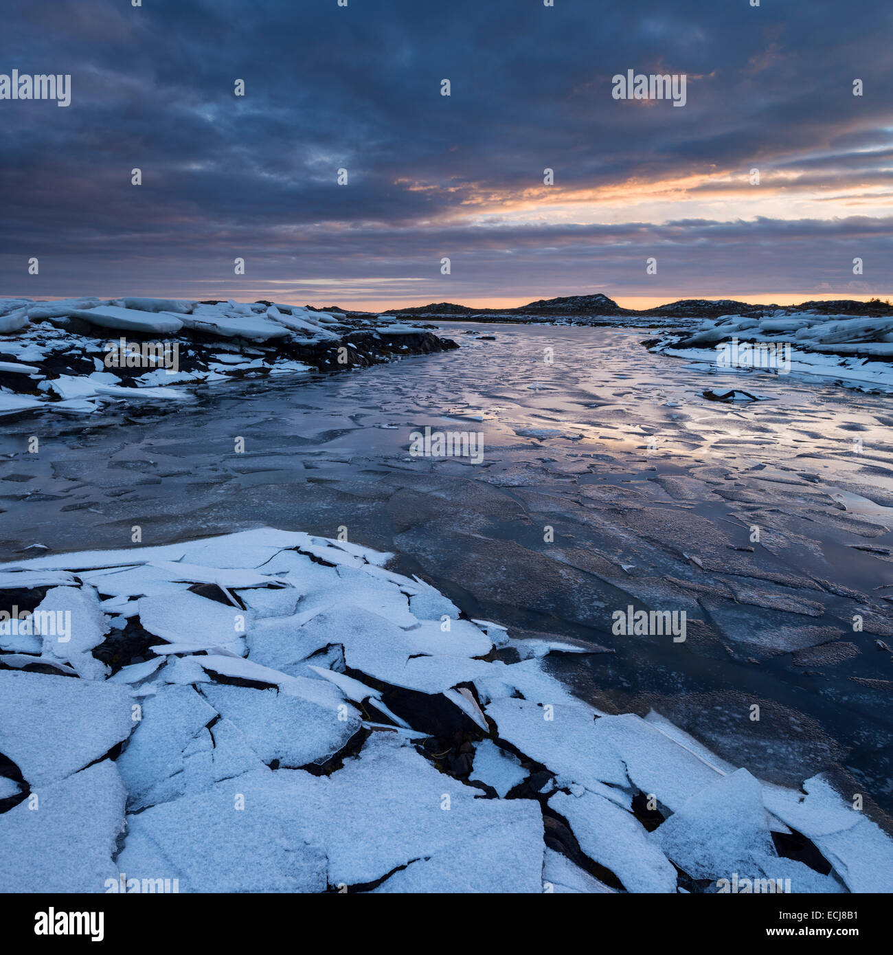 Frozen ice covers coastline in winter, near Nedredal, Vestvågøy, Lofoten Islands, Norway Stock Photo