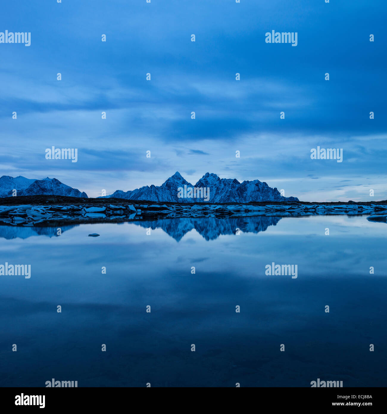 Reflection of Vågakallen mountain peak over coastline, Vestvågøy, Lofoten Islands, Norway Stock Photo