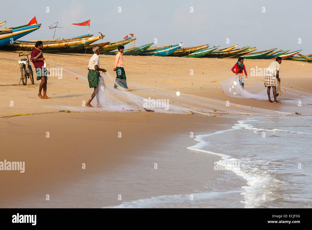 India, Odisha, Konarak, men fishing with a net from the beach Stock
