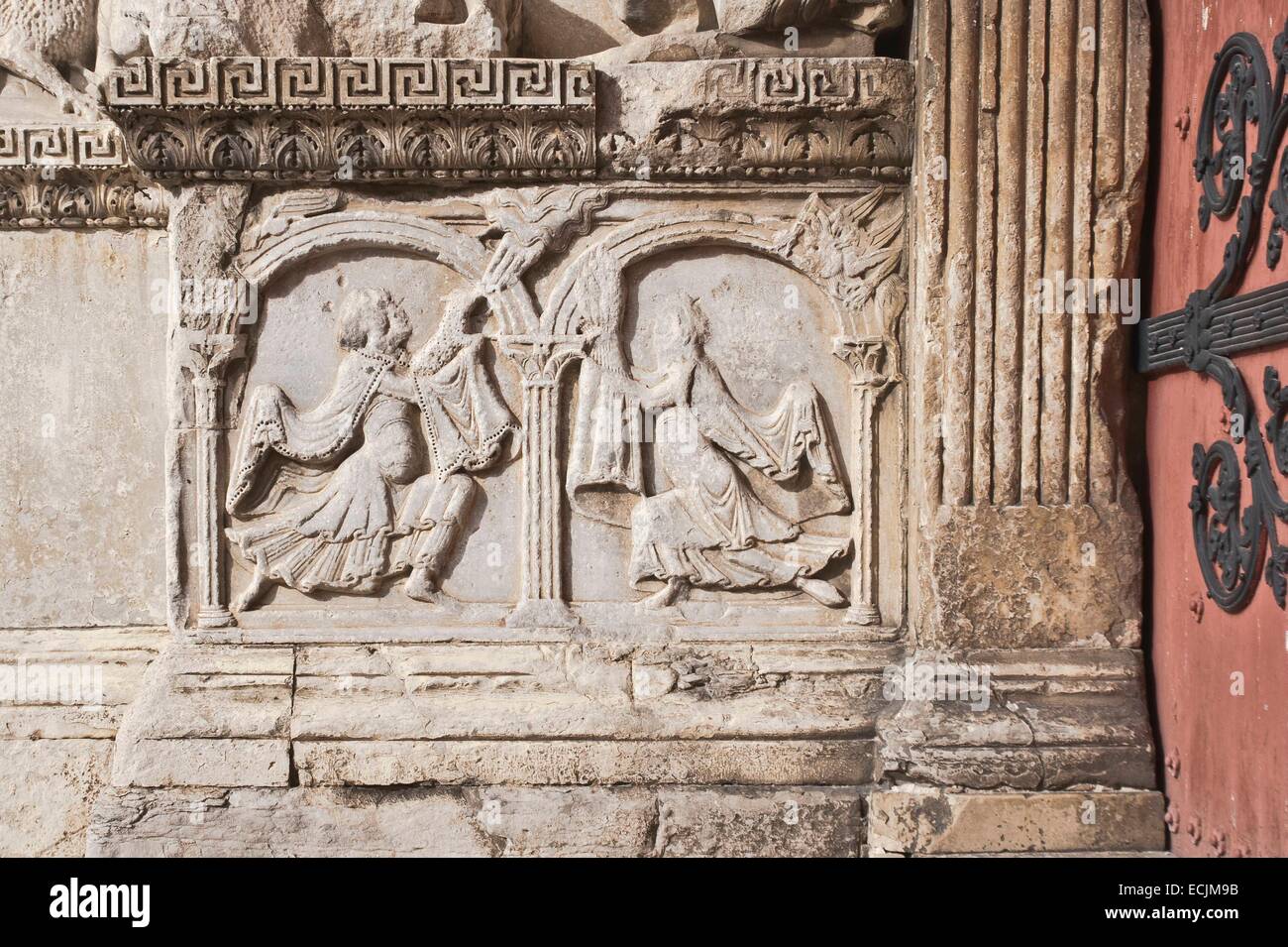 France, Gard, Saint Gilles, 12th-13th century abbey, listed as World Heritage by UNESCO under the road to St Jacques de Compostela in France, Provencal Romanesque style, left pillar of the central portal, Table Cain right offering to the Lord a sheaf of w Stock Photo