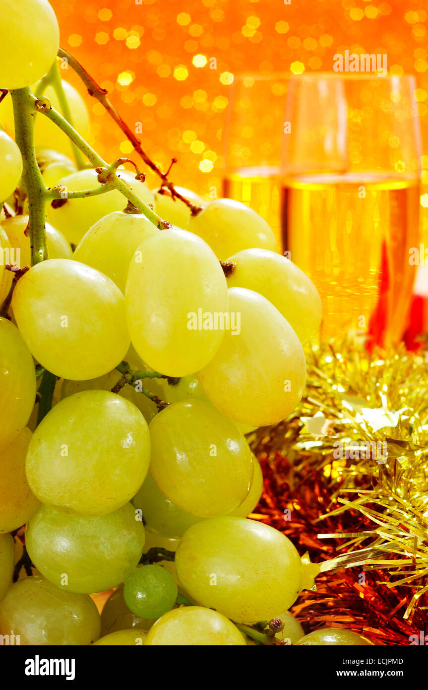 a bunch of the spanish grapes of luck and glasses with champagne, with