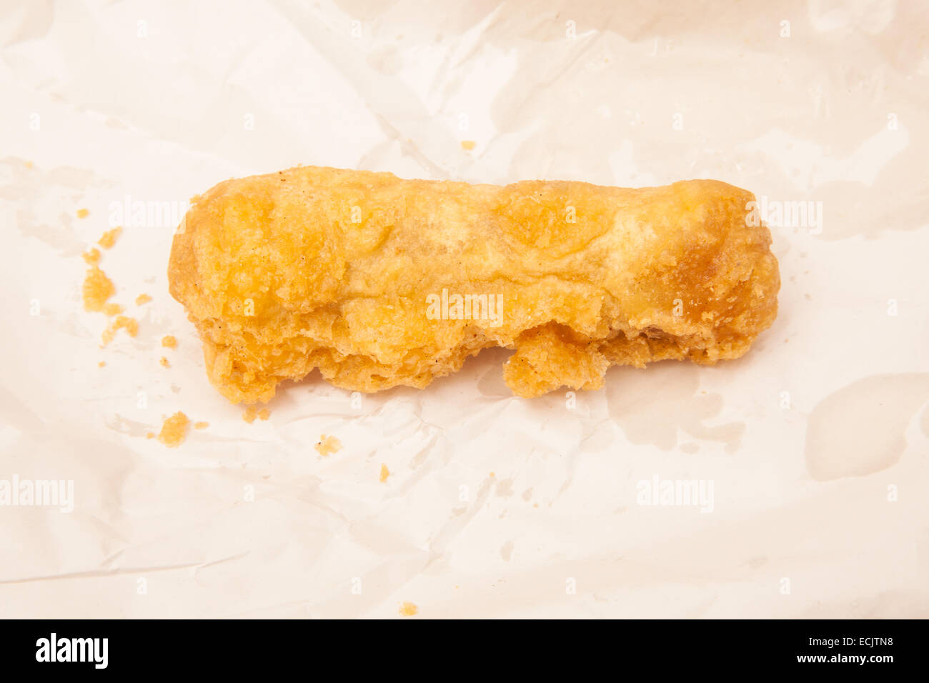 Deep fried pork sausage fresh from the fish and chip shop. Stock Photo