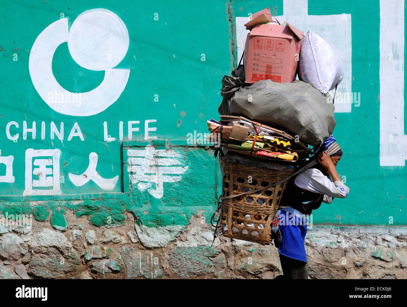 China, Yunnan Province, woman carrying a load Stock Photo