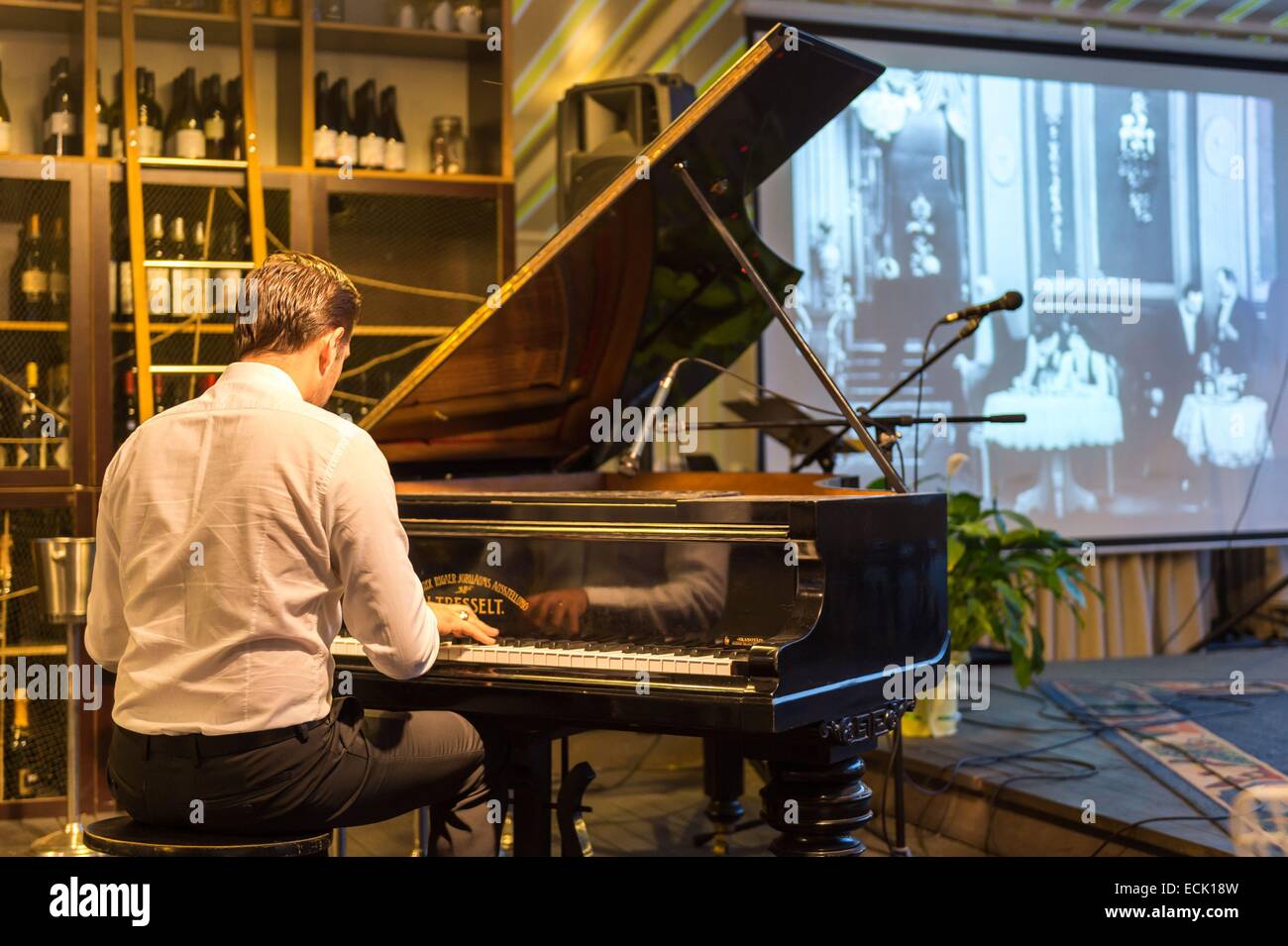 Latvia, Vidzeme, Riga, European capital of culture 2014, historical centre listed as World Heritage by UNESCO, piano player in Jana Scta street Stock Photo