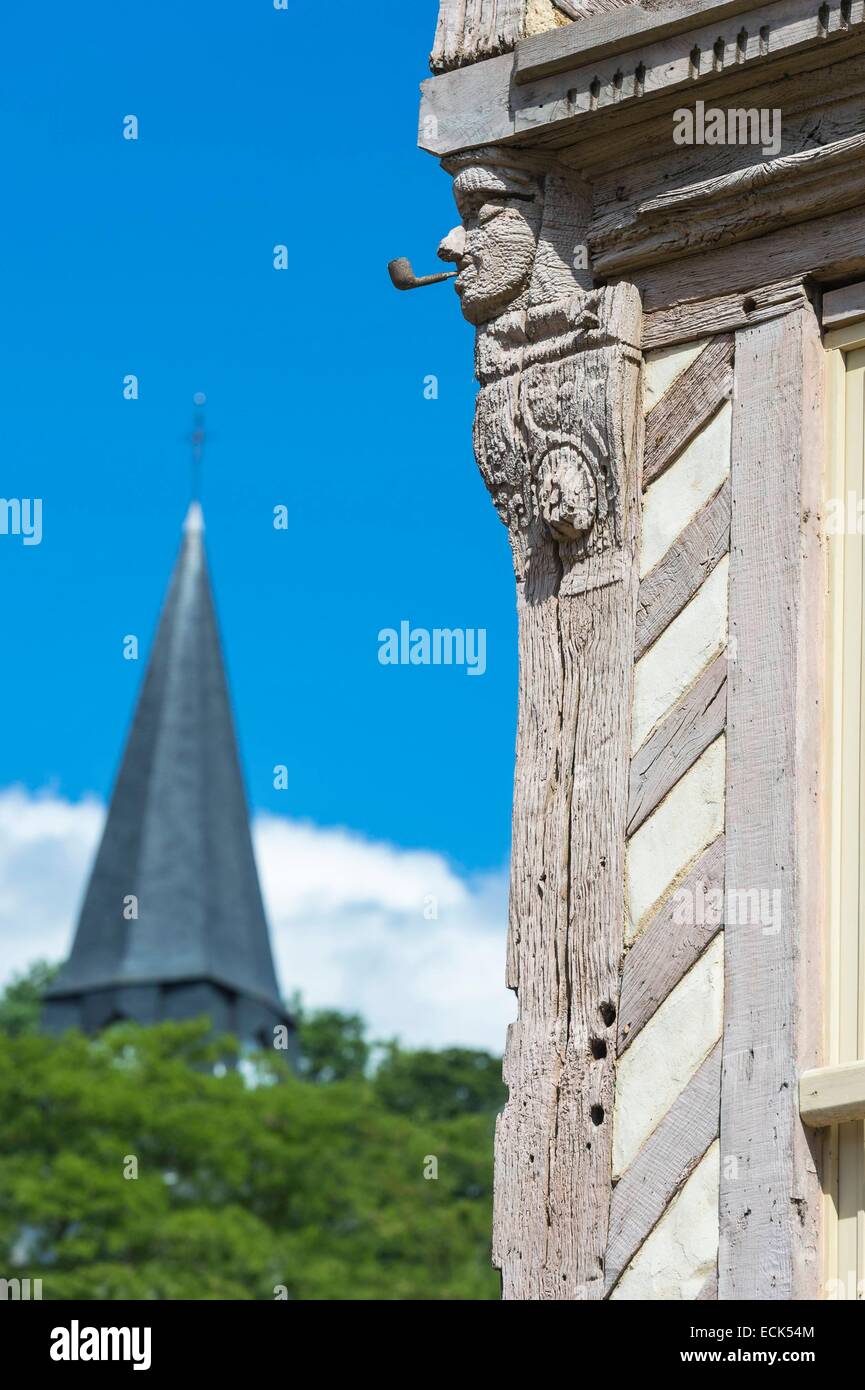 France, Eure, Cormeilles, Bonhomme Cormeilles is 16th century wooden sculpture, steeple of Sainte Croix church in the background Stock Photo