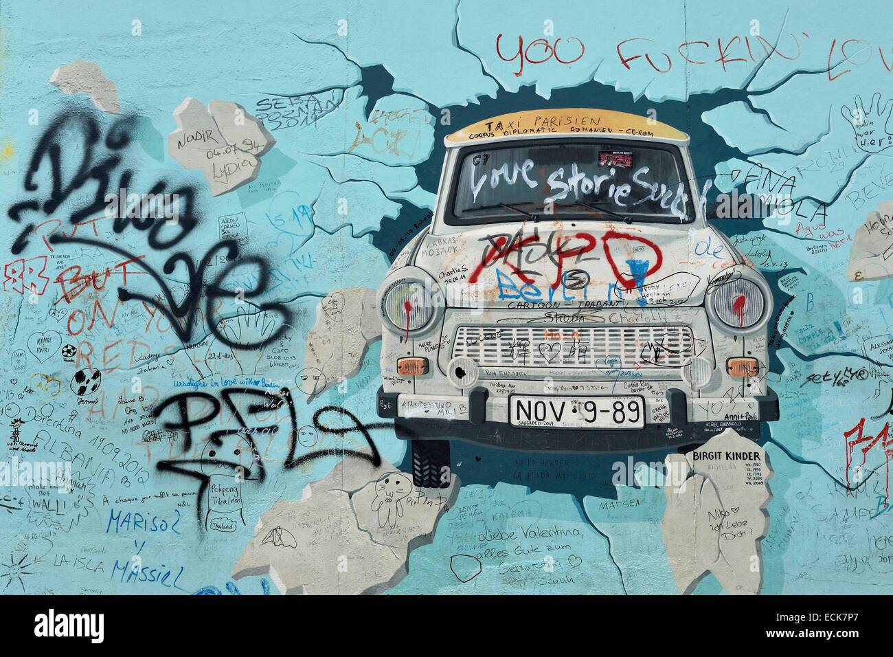 Germany, Berlin, Friedrichshain-Kreuzberg, East Side Gallery, The Wall, work by Birgit Kinder dating from the 1990's, renovated in 2009, representing a Trabant arriving in East Berlin, entitled Test the Best Stock Photo