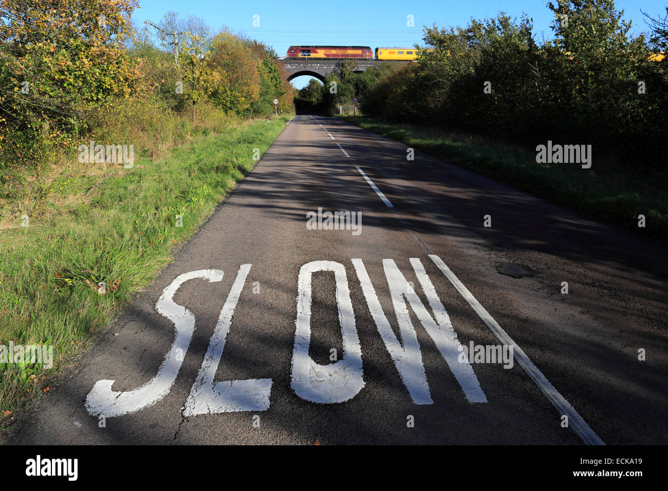 SLOW road sign to illustrate concepts for trains and motion, Electric Trains, East Coast Main Line, Cambridgeshire, England, UK Stock Photo