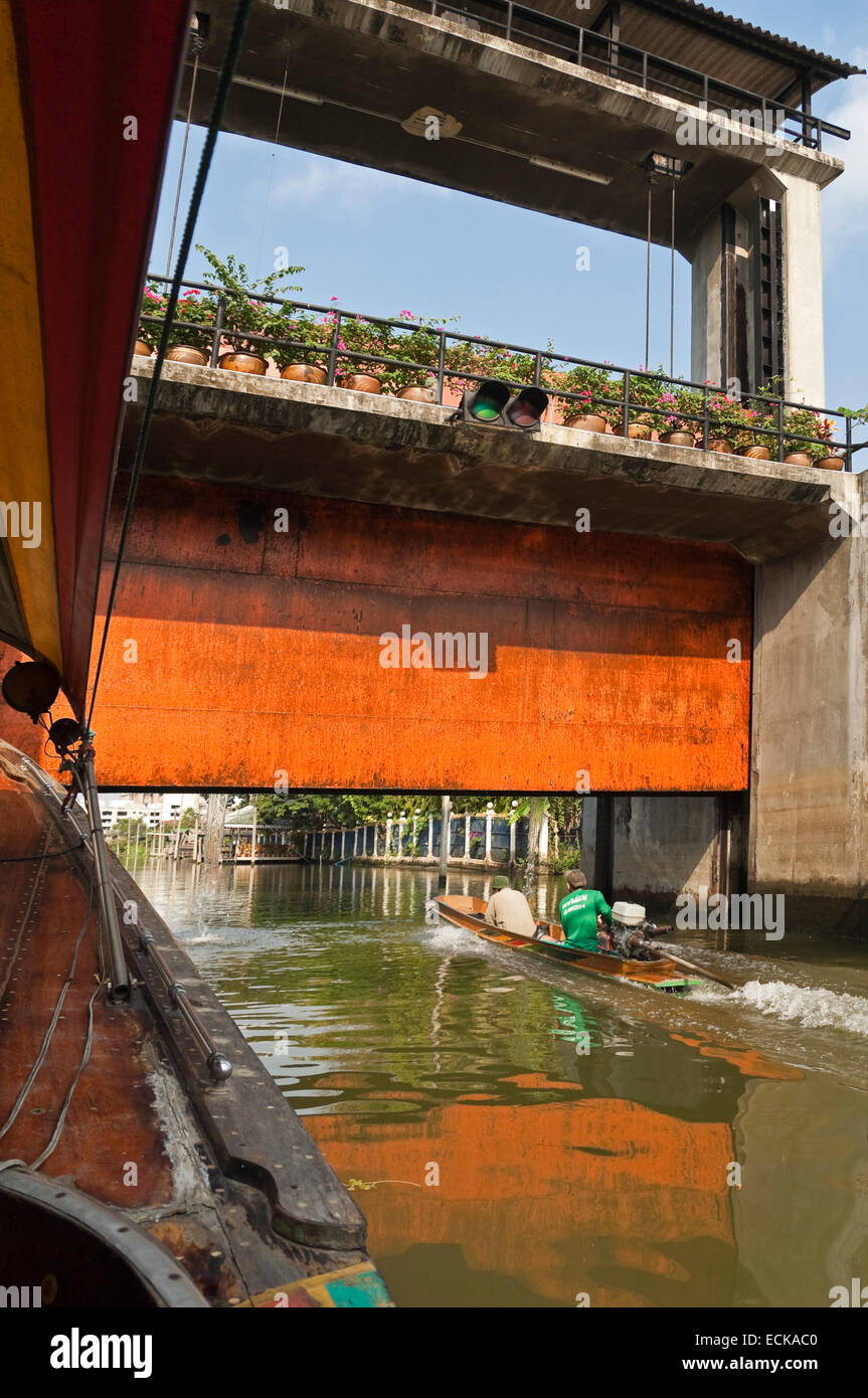 Horizontal riverscape of boats waiting to go through a lock on the canals in Bangkok. Stock Photo