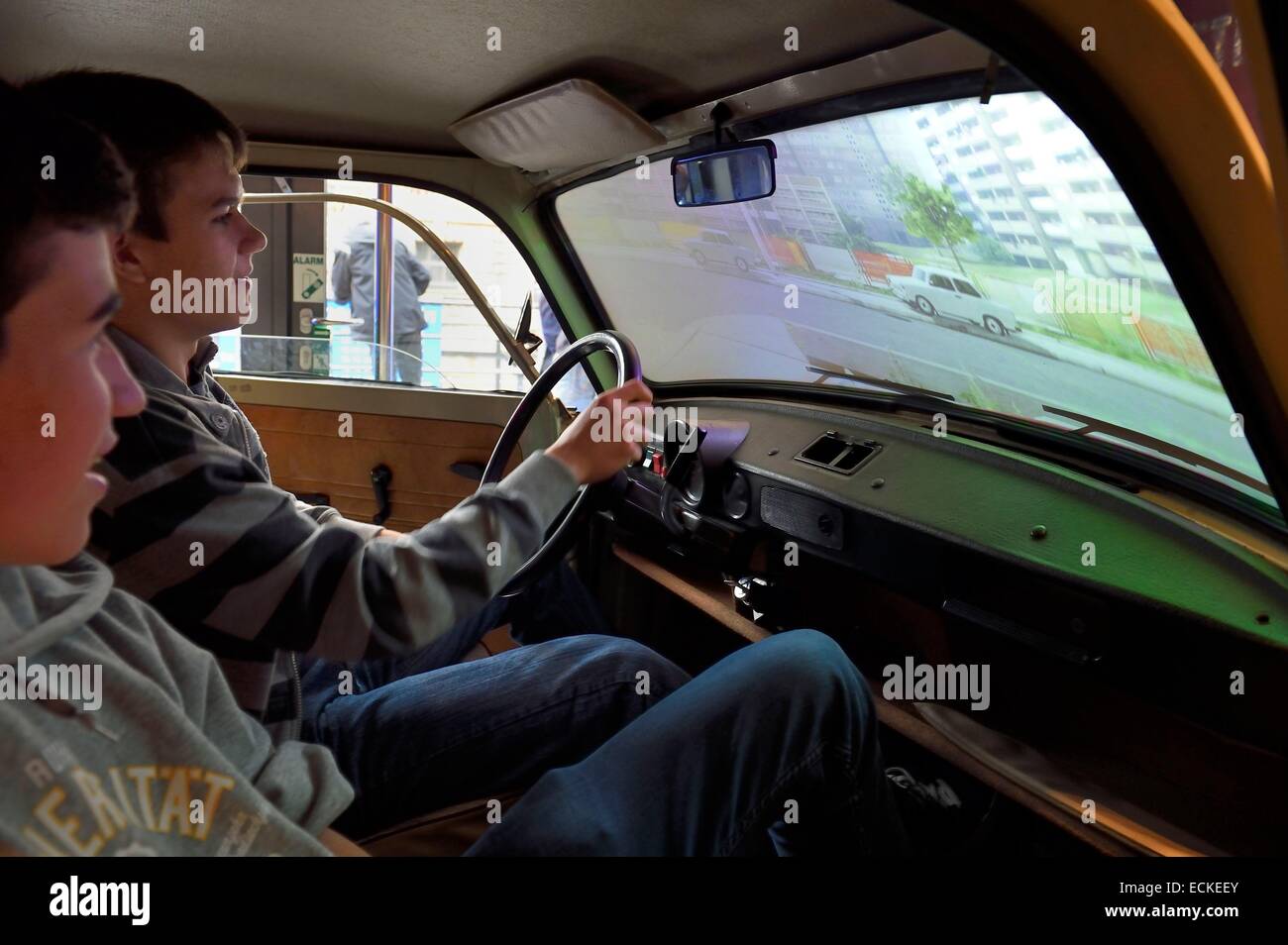 Germany, Berlin, DDR Museum, a museum opened in 2006 to recall the everyday life of former East Germany, teenagers driving virtually a Trabant Stock Photo