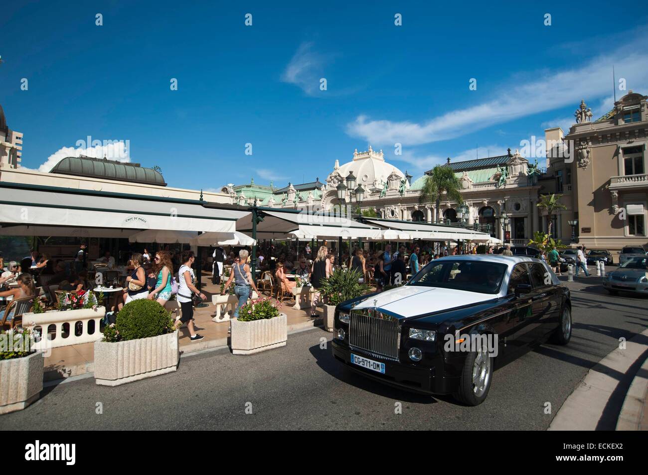 Principality of Monaco, Monaco, Montecarlo, Place du Casino, A Rolls-Royce passing by Cafe de Paris and Casino Stock Photo