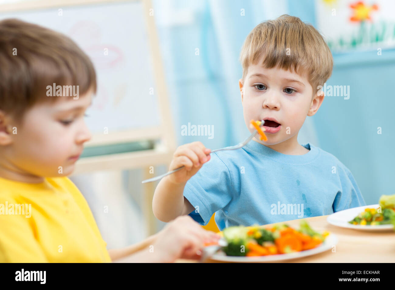 kids eating in kindergarten Stock Photo