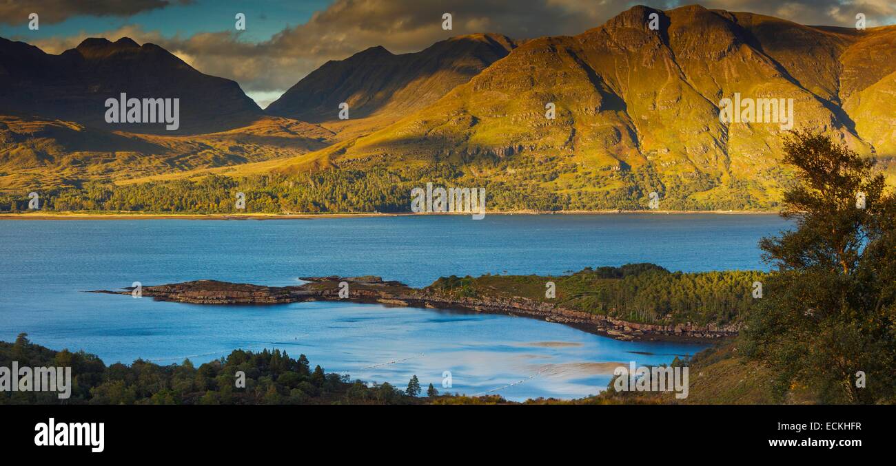 United Kingdom, Scotland, Wester Ross, Upper Loch Torridon, panoramic natural landscape of wild peninsula in a bay on a mountainous background at sunset in autumn Stock Photo