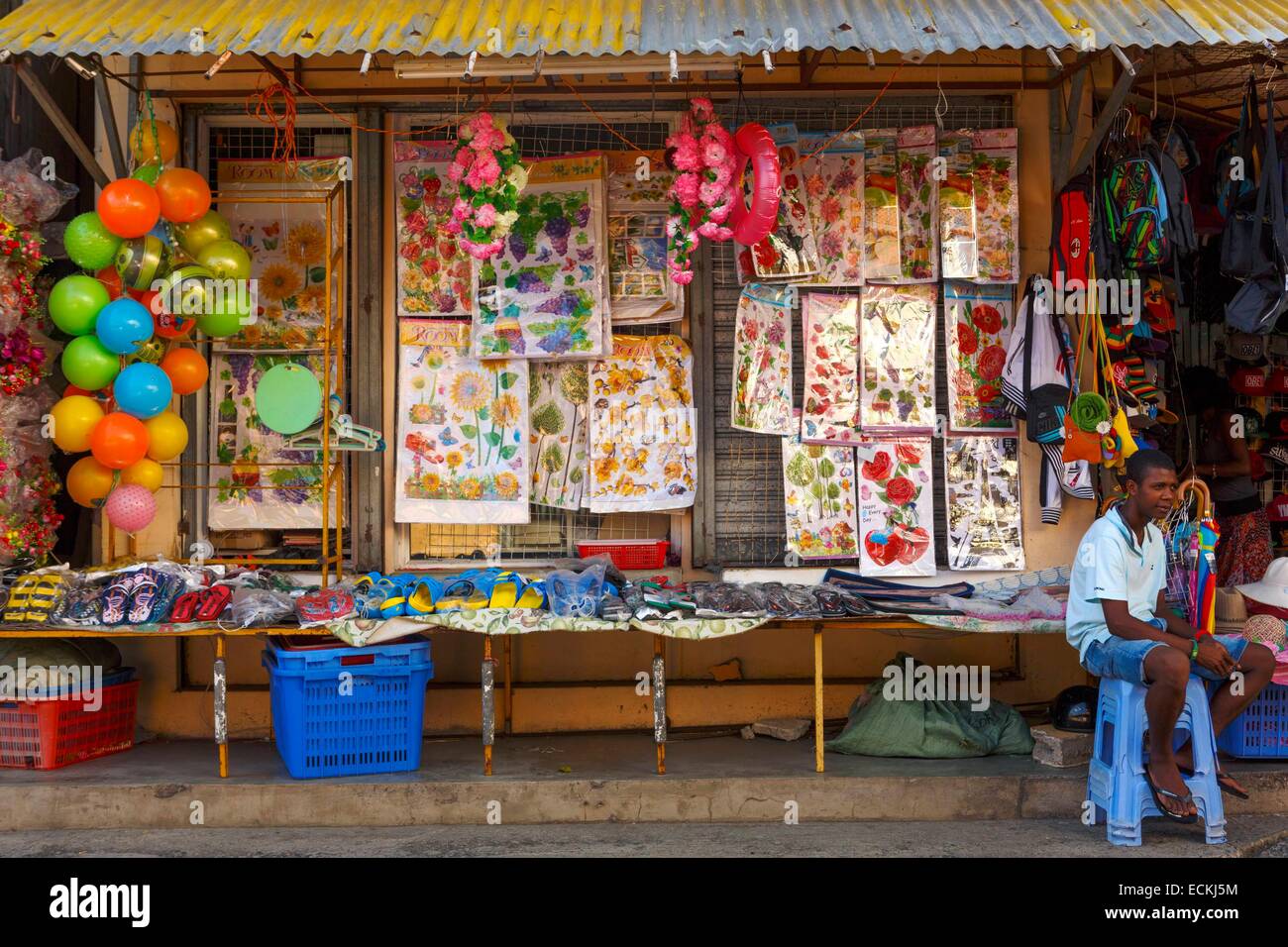 Mauritius, Rodrigues Island, Port Mathurin, sellers sitting in front of