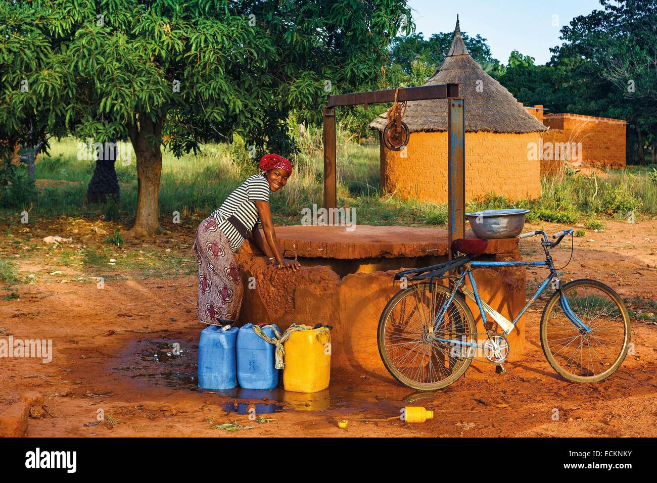 Burkina Faso, Bobo Dioulasso, Toussiana, portrait of a young African girl drawing water in a traditional well Stock Photo