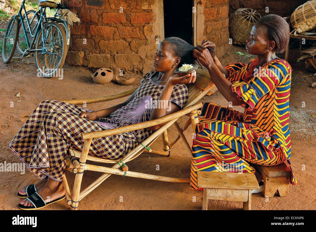Burkina Faso, Bobo Dioulasso, Toussiana, portrait of two women trying to apply a cream containing shea to take care of their hair Stock Photo