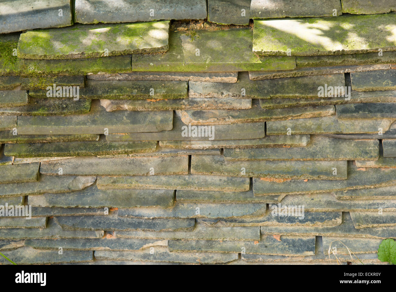 piled Korean traditional old mossy black roof tiles Stock Photo