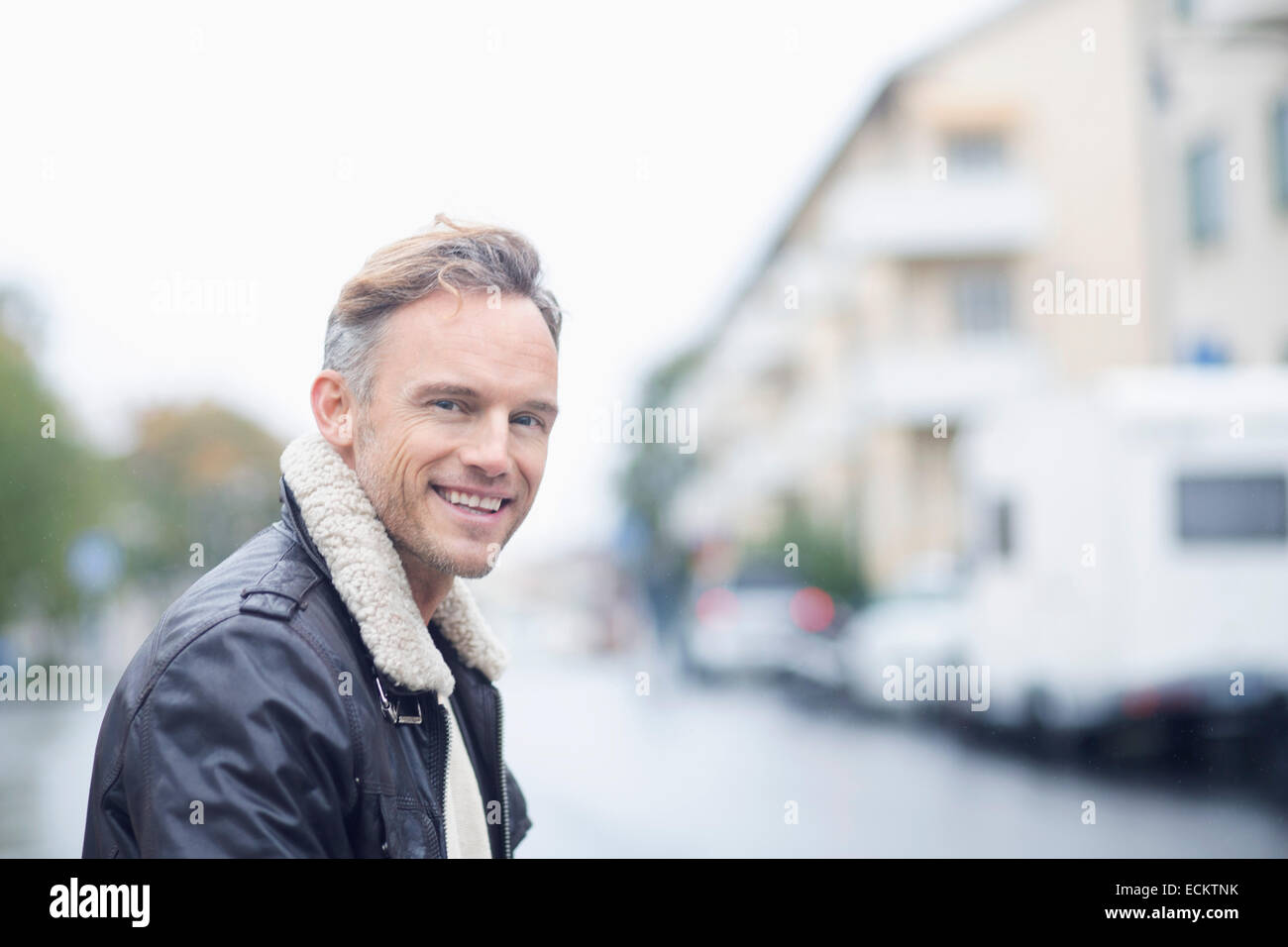 Side view portrait of smiling mature man on street Stock Photo