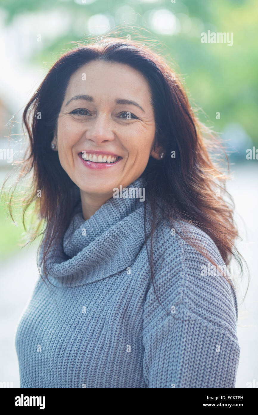 Portrait of smiling woman in park Stock Photo - Alamy