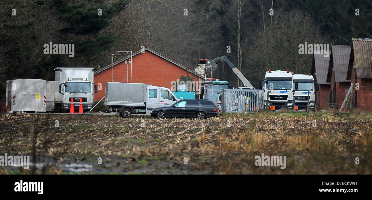 Lower Saxony, Germany. 16th Dec, 2014. Men in protective suits kill circa 20 000 turkeys on a poultry farm near Barßel, Lower Saxony, Germany, 16 December 2014. A bucket wheel excavator loaded with gassed turkeys in the background. The H5N8 avian influenza was detected within the turkey population of the farm. Because of that, all the farms animals are to be killed with gas, which is loaded onto trucks parked between the barn buildings. PHOTO: INGO WAGNER/dpa Credit:  dpa picture alliance/Alamy Live News Stock Photo