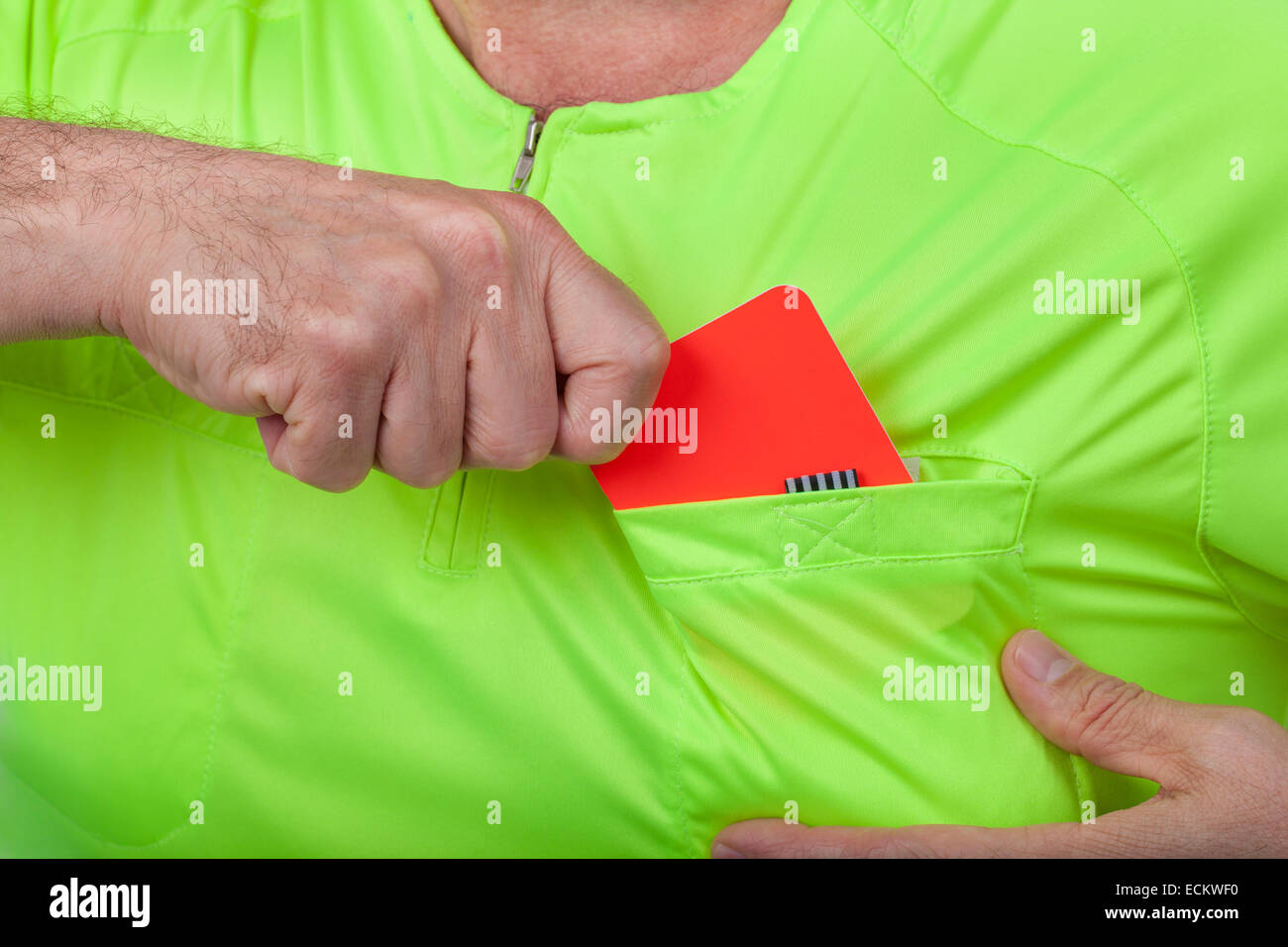 Referee whips out a red card from his pocket. Stock Photo