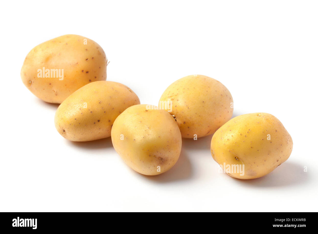 Several fresh potatoes isolated on white background. Stock Photo