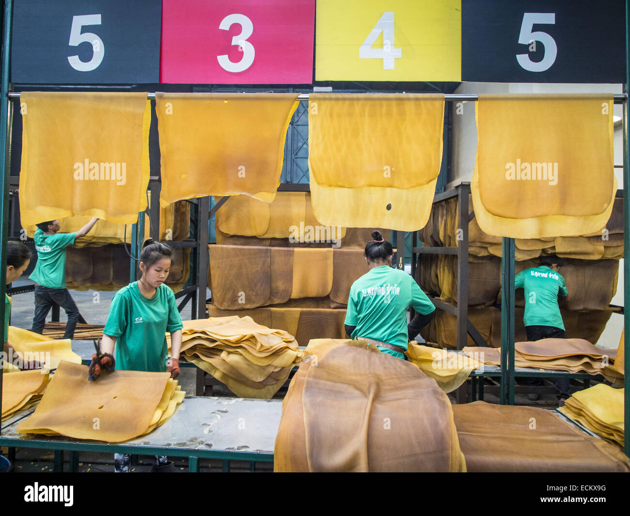 Klaeng, Rayong, Thailand. 15th Dec, 2014. Workers sort dried rubber