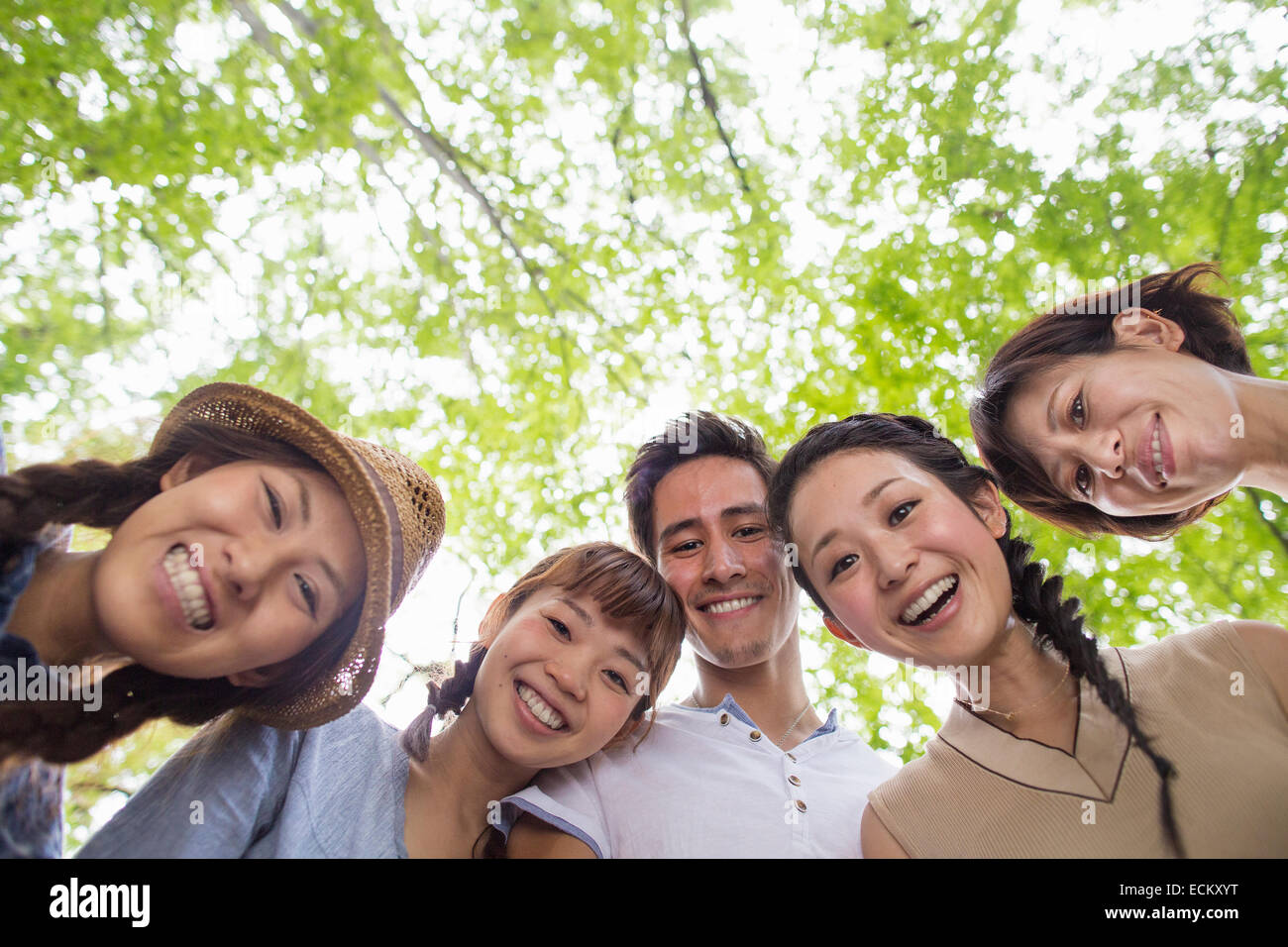 Group of friends at an outdoor party in a forest. Stock Photo