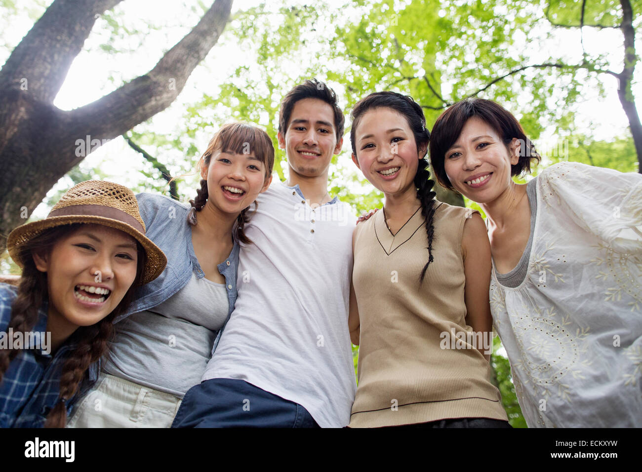 Group of friends at an outdoor party in a forest. Stock Photo