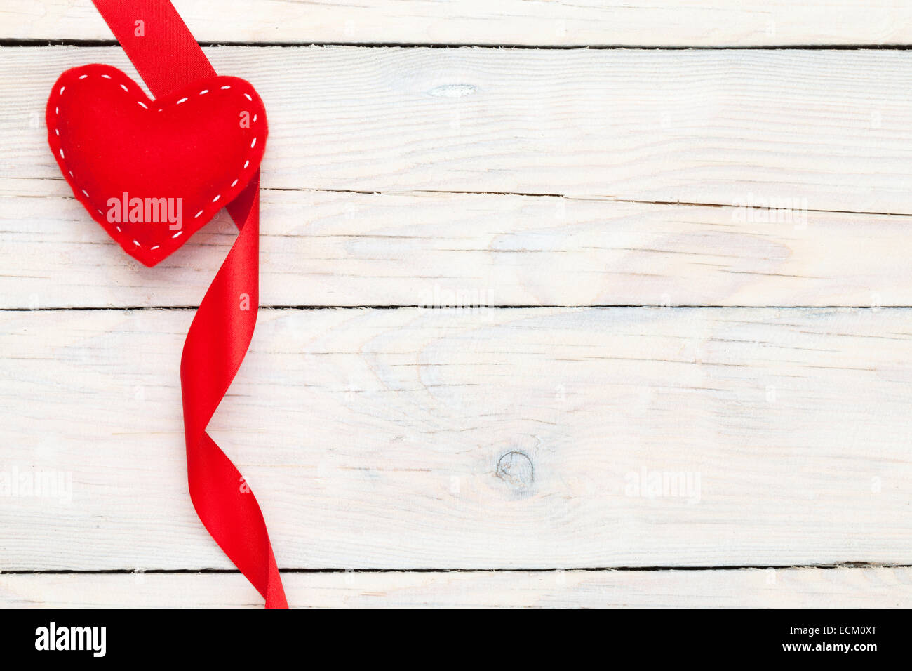 Valentines day toy heart and ribbon over wooden table background with ...